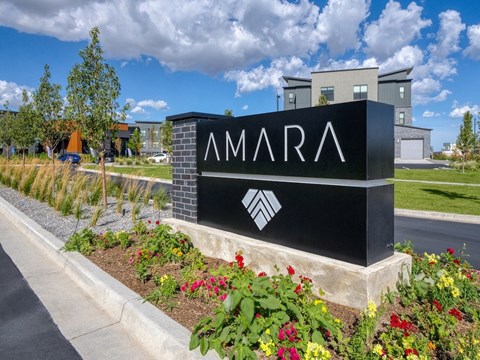 A sign that says "AMARA" in front of some buildings.