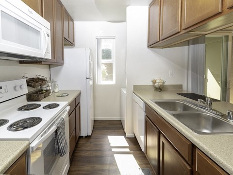 a kitchen with a stove sink and a microwave