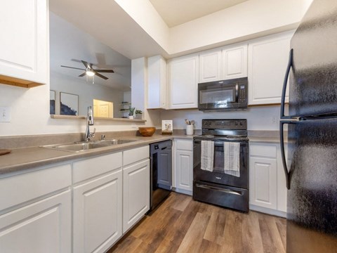 a kitchen with stainless steel appliances and white cabinets