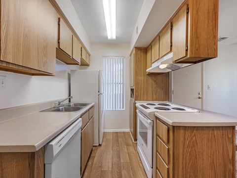 A kitchen with wooden cabinets and white appliances.