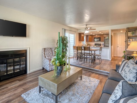 A living room with a fireplace and a television mounted on the wall.