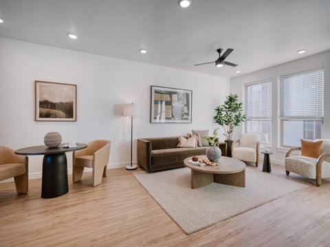 A living room with a black coffee table and a brown chair.