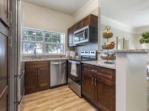 a kitchen with stainless steel appliances and wooden cabinets