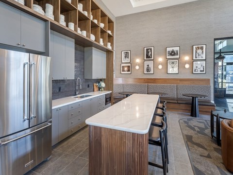 A modern kitchen with a stainless steel refrigerator and wooden accents.
