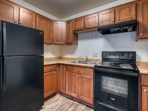 Kitchen with Black Appliances at Peppertree