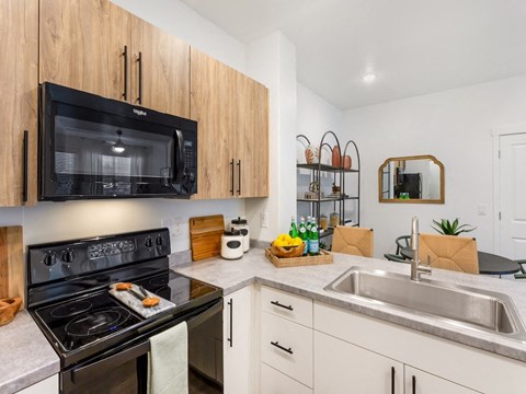a kitchen with a stove microwave and sink