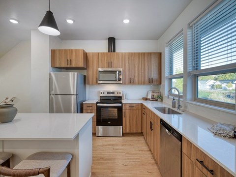 Kitchen with Brown Cabinets at The Amber