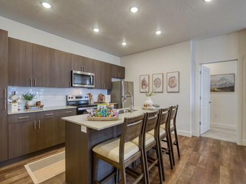 A kitchen with brown cabinets and a white island.