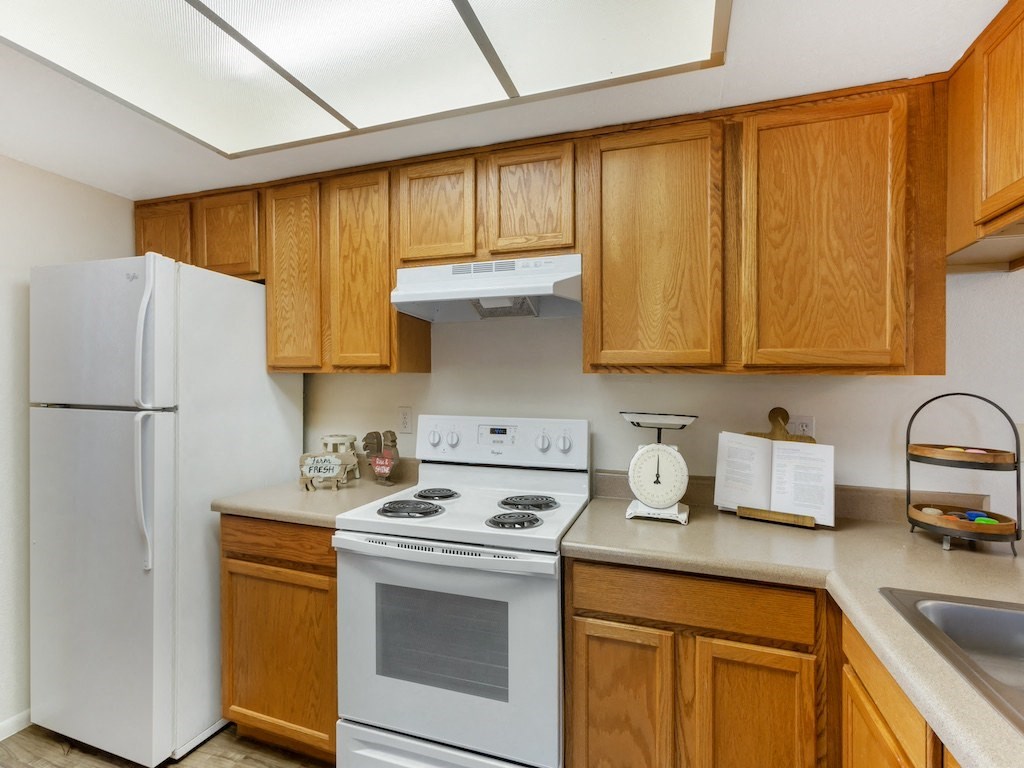 Kitchen with White Appliances at Aztec Springs