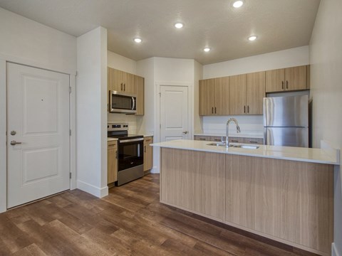 A kitchen with wooden cabinets and a white countertop.