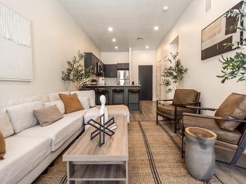 A modern living room with a white sofa and a wooden coffee table.
