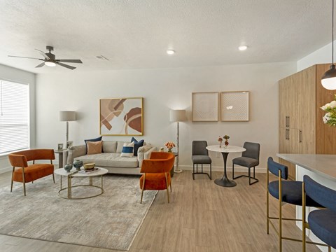 a living room and dining room with a table and chairs