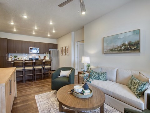 A living room with a couch, chairs, and a coffee table.