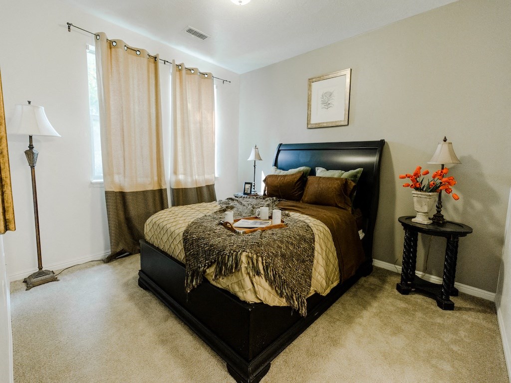 Primary  Bedroom with Large Window at Falls at Riverwoods