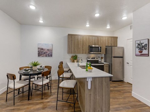 an open kitchen and dining area with a table and chairs