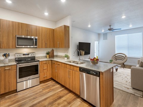 a kitchen with wooden cabinets and stainless steel appliances