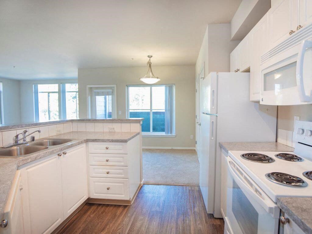 Kitchen With White Cabinetry And Appliances at Metropolitan Collection Apartments, Washington