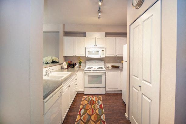 Kitchen With White Cabinetry And Appliances Kitchen With White Cabinetry And Appliances at Metropolitan Place Apartments, Renton, WA, 98057 - Photo Gallery