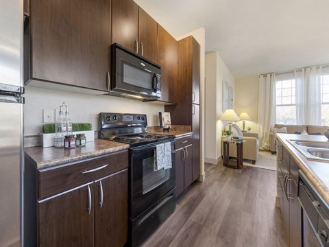 a kitchen with stainless steel appliances and wooden cabinets