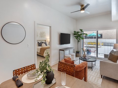 A living room with a brown chair and a white table.
