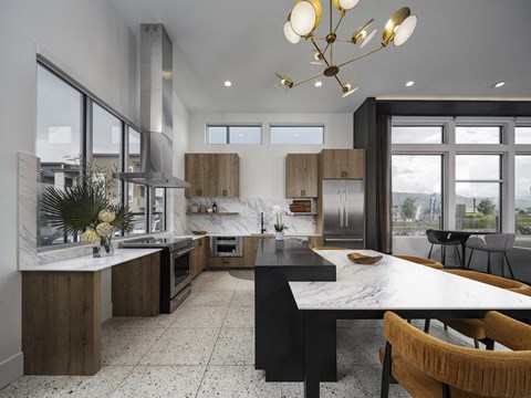 a kitchen and dining area with a table and chairs and a large window