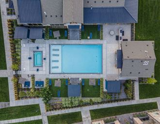 an aerial view of a house with a large pool in the backyard
