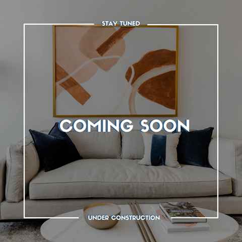 a living room with a couch and the words coming soon under construction
