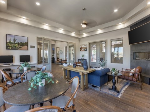 A modern living room with a dining table and chairs.