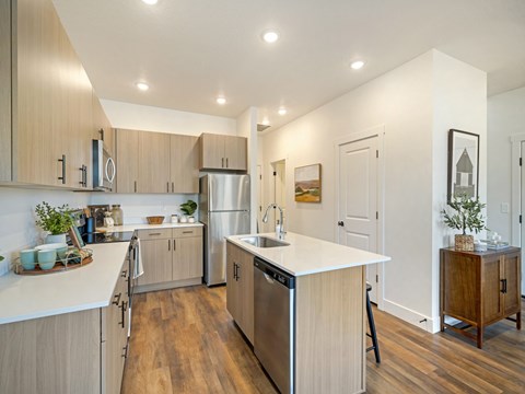 A modern kitchen with wooden cabinets and a white countertop.