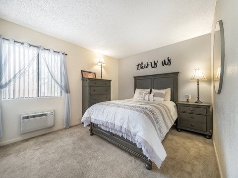 the master bedroom has a king sized bed and a window