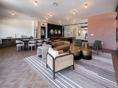 A living room with a grey carpet and a white sofa.
