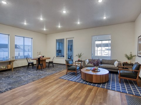 A living room with a wooden floor and furniture.