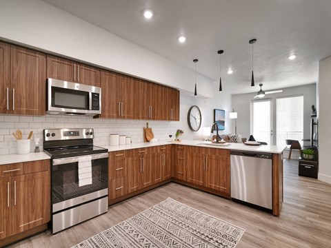 A modern kitchen with wooden cabinets and stainless steel appliances.