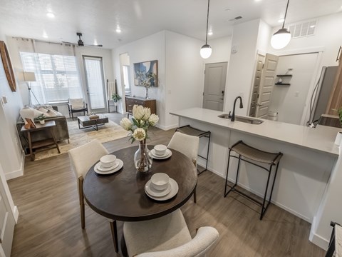 A dining room with a table set for two.