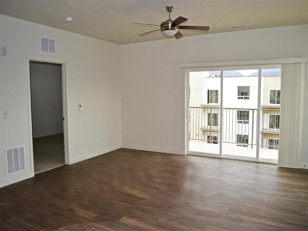 Open Living Area with Woodgrain Flooring at Kimpton Square Open Living Area with Woodgrain Flooring at Kimpton Square Senior Apartments, Midvale, UT 84045