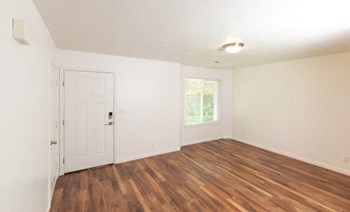 Wood Floor Living Room at Devonshire Court Apartments & Townhomes, North Logan, Utah - Photo Gallery 18