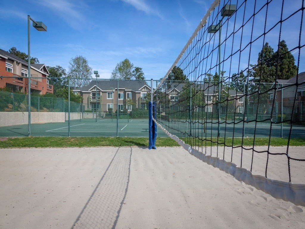 a tennis court with a person standing on the side of a net