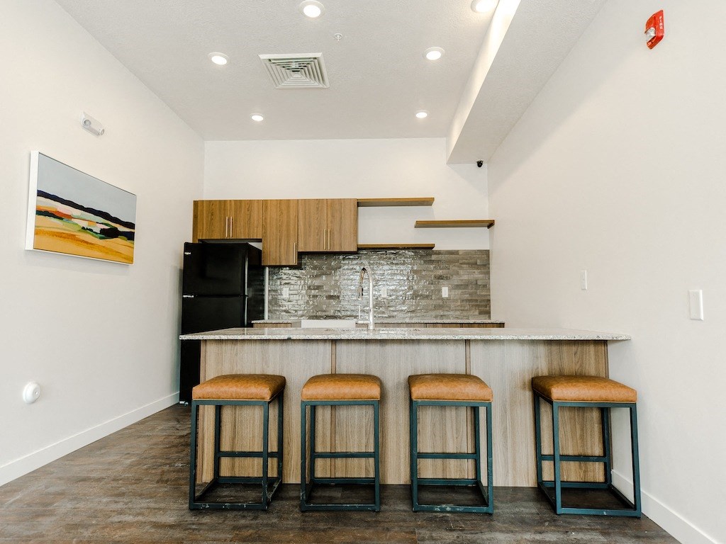 Community Kitchen with Island & Wood Grain Cabinets at Meadows at Homestead Logan UT