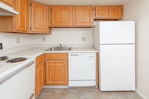 a kitchen with white appliances and wooden cabinets