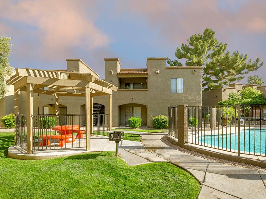 Beautiful Courtyard with Pool & Cabana building exterior and beautiful green grass landscaping at Glen Oaks Apartments, Glendale, AZ