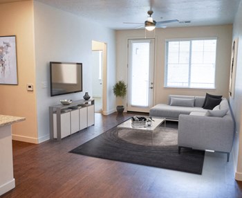 Living Room With Plenty Of Natural Light at Falls at Riverwoods Apartments & Townhomes, Logan, 84321