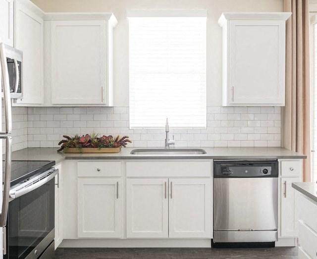 White Cabinetry In Kitchen with Stainless Steel Appliances at Rivulet Apartments, American Fork, UT