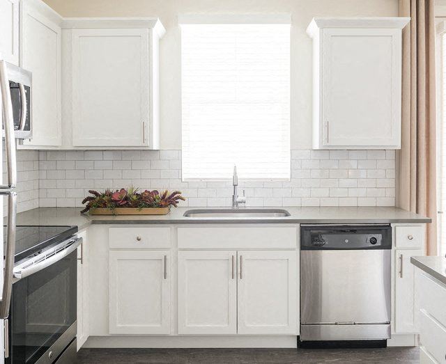 White Cabinetry In Kitchen with Stainless Steel Appliances White Cabinetry In Kitchen at Rivulet Apartments, American Fork, UT