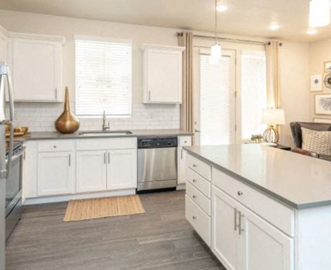 a kitchen with white cabinets and a counter top