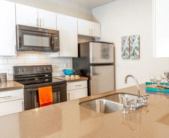 Kitchen With Stainless Steel Appliances at San Tropez Apartments & Townhomes, Utah