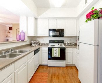 Kitchen With White Cabinetry And Appliances Kitchen With White Cabinetry And Appliances at Trailside Apartments, Parker, Colorado - Photo Gallery 3