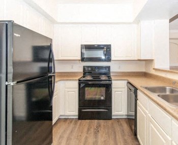 Refrigerator And Kitchen Appliances Refrigerator And Kitchen Appliances at Trailside Apartments, Colorado - Photo Gallery 4