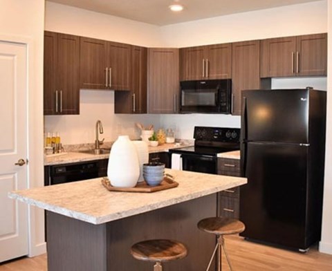 a kitchen with a counter top and a refrigerator