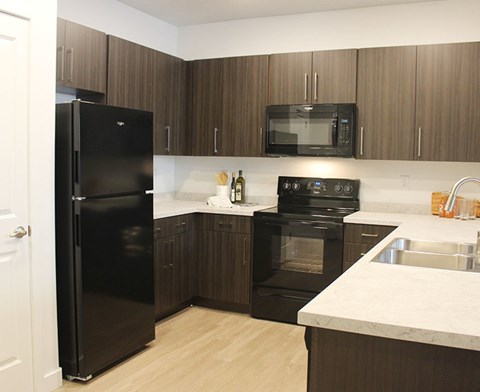 a kitchen with black appliances and white counter tops