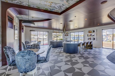 A modern dining room with a large table and chairs.